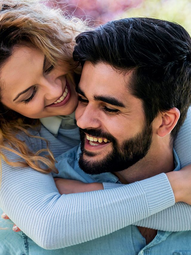 young-woman-hugging-partner-from-behind