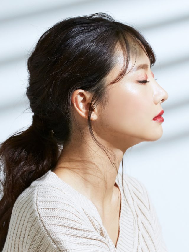 Beauty portrait of young Asian woman on the light and shadow background